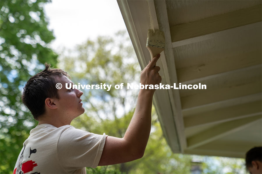 Pi Kappa Alpha’s Cole Geer paints the exterior of a garage during the Big Event. May 4, 2024. Photo by Kirk Rangel for University Communication.